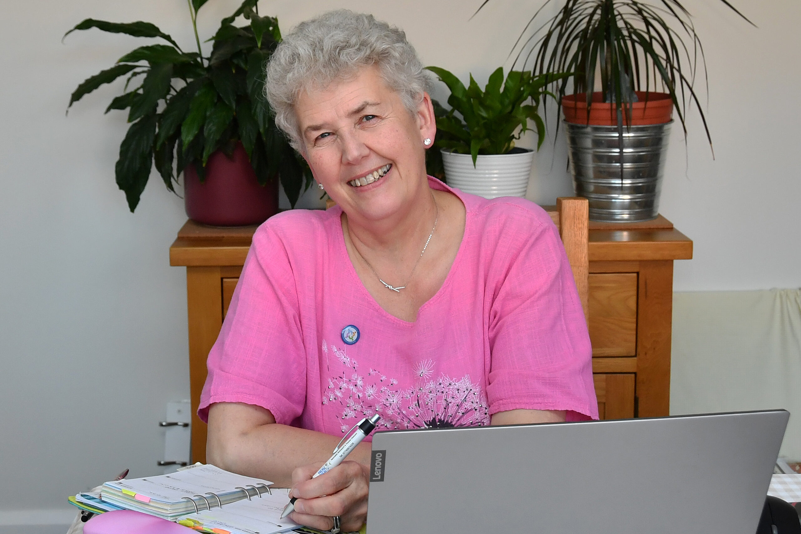 Kerry entering a booking in her diary