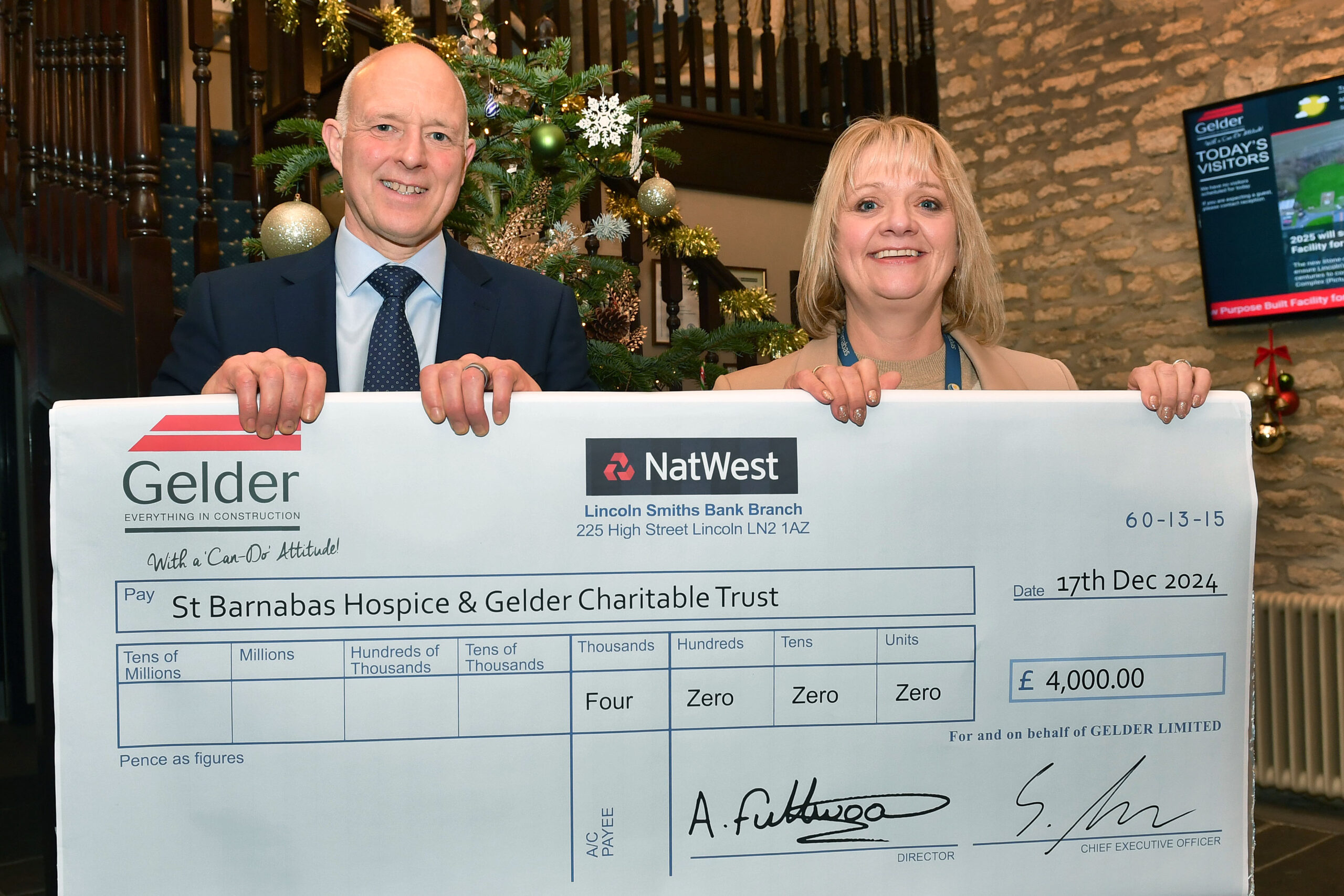 Gelder Group CEO Steve Gelder presents St Barnabas Hospice Head of Funding & Lottery with a share of money raised by an Halloween Experience